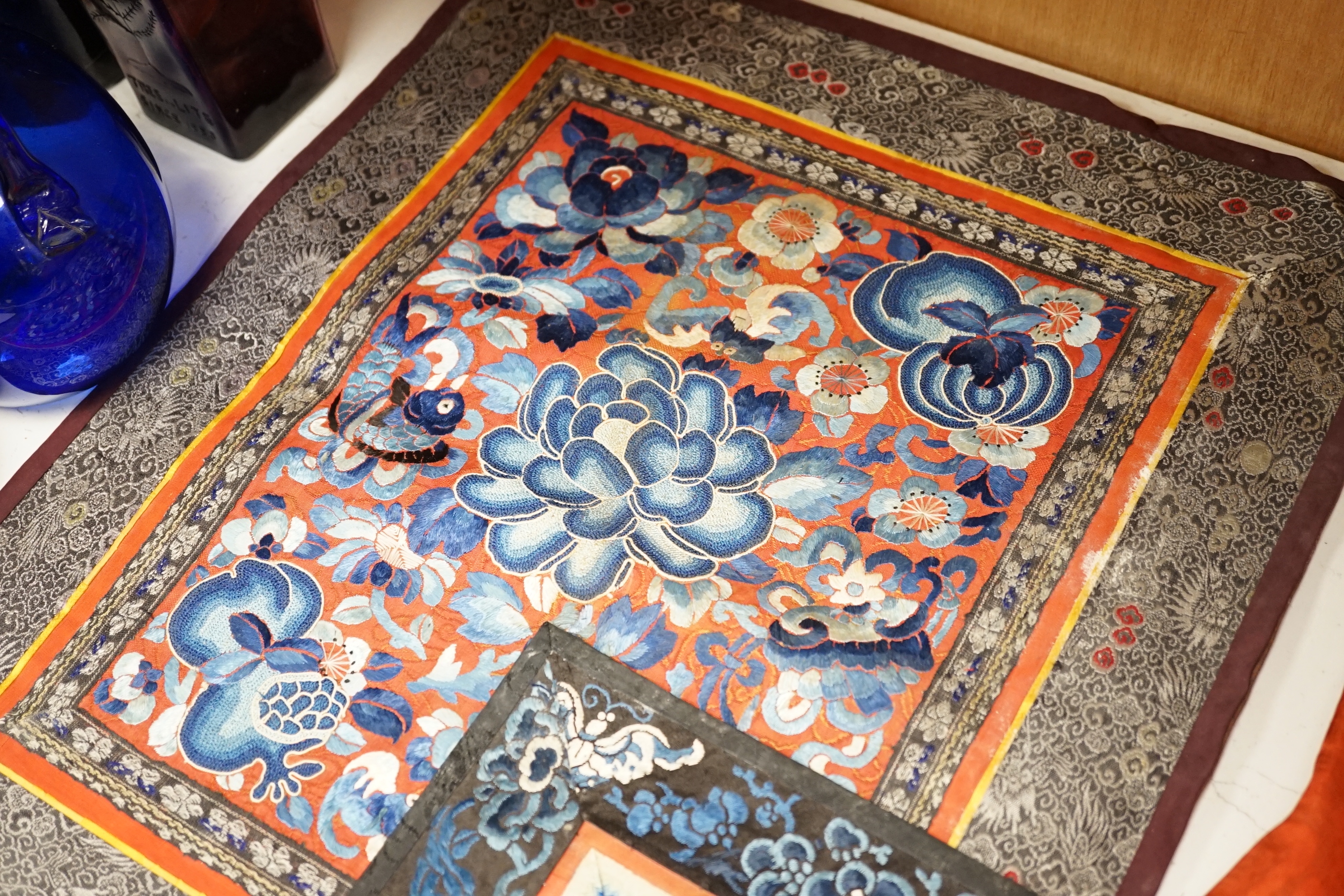 Six panels of Chinese silk embroidered mats, all using mixed stitches including Beijing knot, all bordered with silk brocade, largest 36 x 41cm